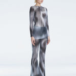 Side view of the Freya Black Flare Pants, featuring a tailored slim fit and flared ankle-length silhouette.

