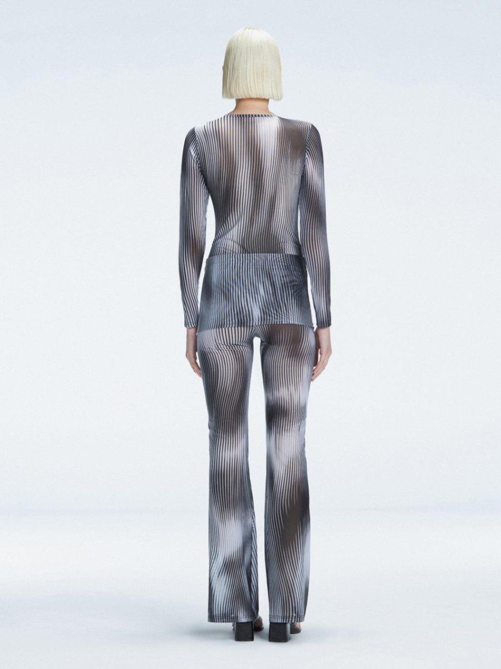 Back view of the Mireya Bodysuit and Freya Pants, emphasizing their figure-enhancing fit and bold color.
