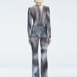 Back view of the Mireya Bodysuit and Freya Pants, emphasizing their figure-enhancing fit and bold color.
