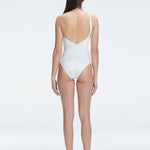 "Model showcasing the back of the Solene White Swimsuit, highlighting the sleek fit and elegant one-shoulder design."
