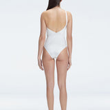 "Model showcasing the back of the Solene White Swimsuit, highlighting the sleek fit and elegant one-shoulder design."
