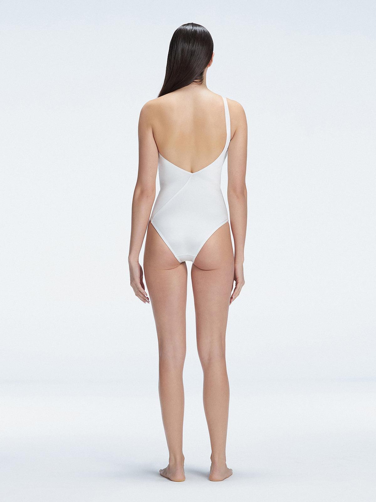 "Model showcasing the back of the Solene White Swimsuit, highlighting the sleek fit and elegant one-shoulder design."
