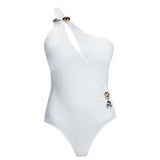 "Solene White Swimsuit laid flat, showing the one-shoulder design, cutout, and ruched waist with buckle detail."
