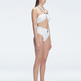 "Side view of the buckle detailing on the Meredith White Halter Neck Bikini Top, emphasizing the chic, trendy design."
