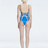 Back view of model wearing Seraphina Blue Optical One Piece, highlighting the sleek fit and moderate coverage.
