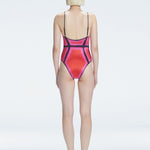 Back view of model wearing Seraphina Red Optical One Piece, highlighting the sleek fit and moderate coverage.
