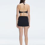 Back view of model wearing Siena Black Mini Skirt, highlighting the two-layered structure and flattering fit.
