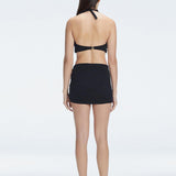 Back view of model wearing Siena Black Mini Skirt, highlighting the two-layered structure and flattering fit.
