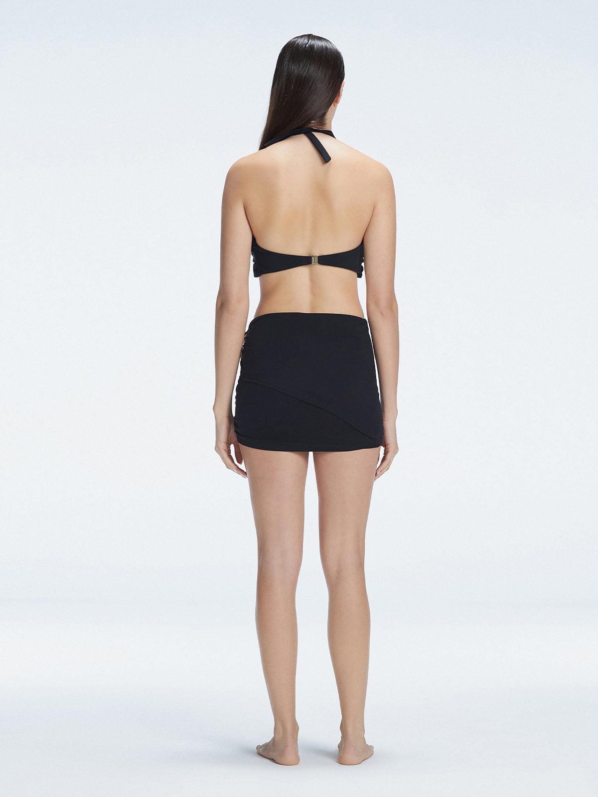 Back view of model wearing Siena Black Mini Skirt, highlighting the two-layered structure and flattering fit.
