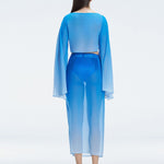 Back view of model wearing Samantha Blue Degraded Top and Tabitha Skirt, highlighting the sleek fit and long sleeves.
