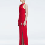 Side view of model showcasing the deep slit and chic buckle on the Louisa Red Knitwear Maxi Dress.
