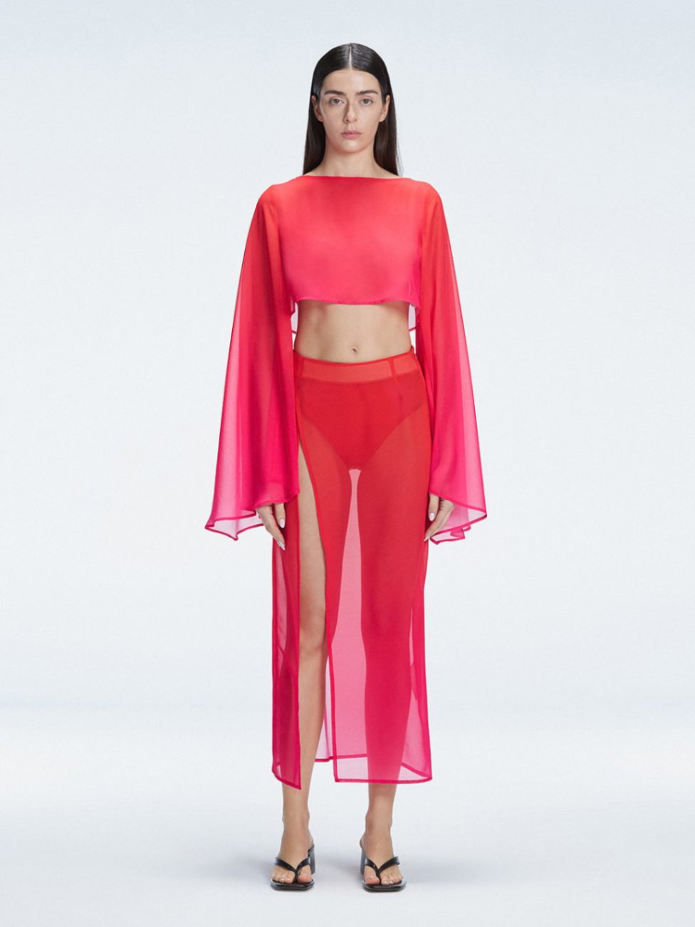 Front view of model wearing Samantha Red Degraded Top with long sleeves and printed mesh fabric.
