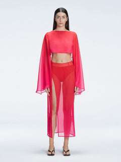Front view of model wearing Samantha Red Degraded Top with long sleeves and printed mesh fabric.
