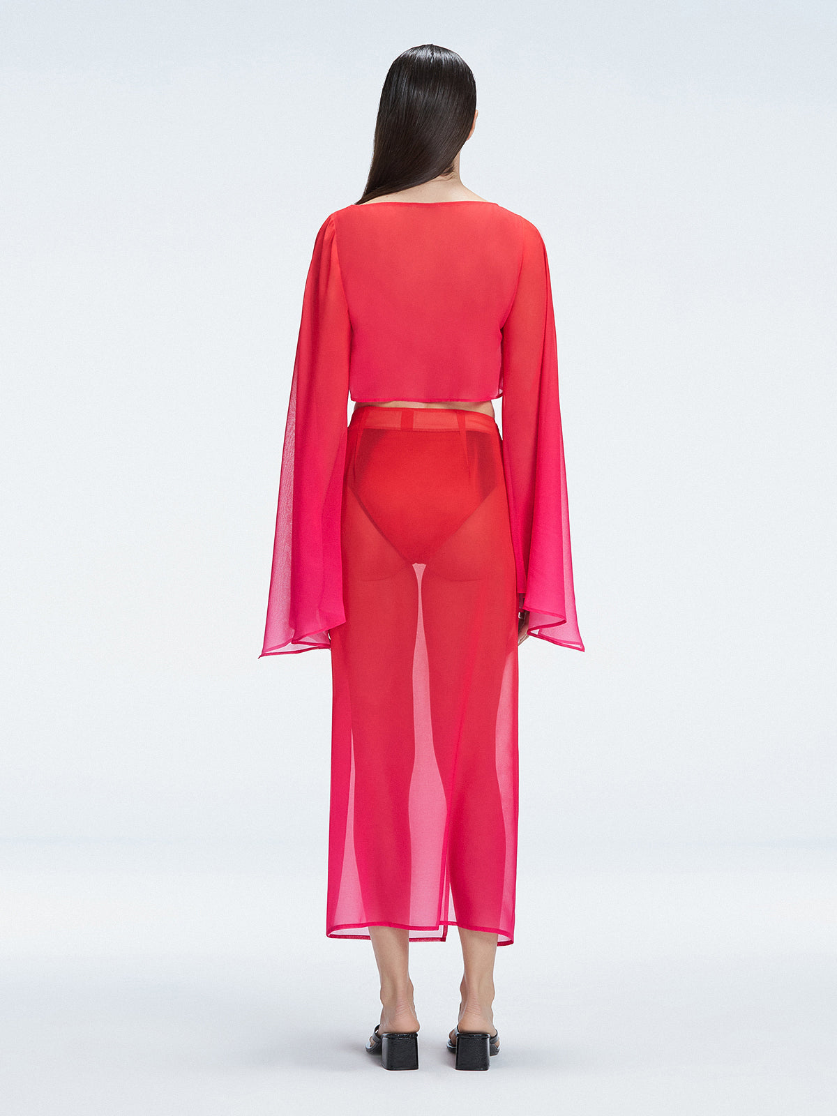 Back view of model wearing Samantha Red Degraded Top, highlighting the sleek fit and long sleeves.
