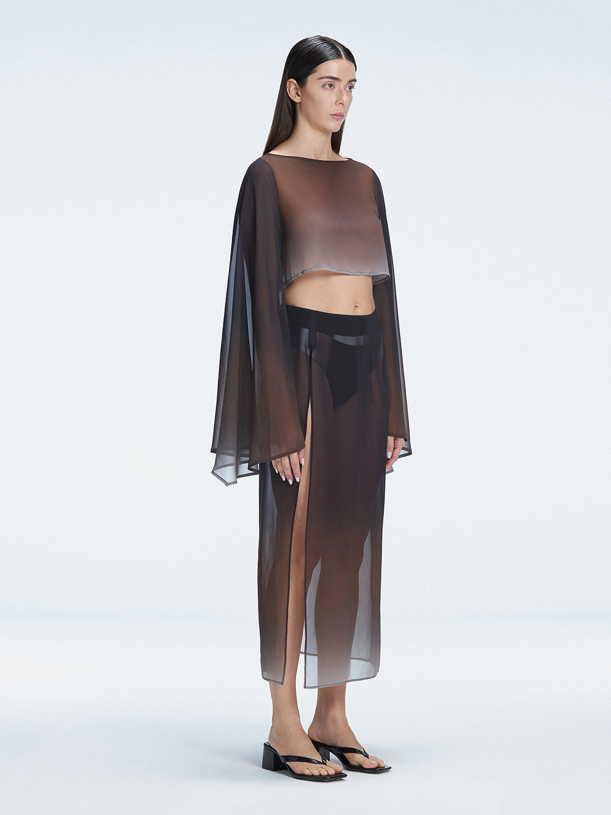 Side view of model showcasing the deep slit and graceful flow of the Tabitha Black Skirt.
