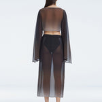 Back view of model wearing Samantha Black Degraded Top and Tabitha Skirt, highlighting the sleek fit and long sleeves.
