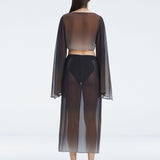 Back view of model wearing Samantha Black Degraded Top and Tabitha Skirt, highlighting the sleek fit and long sleeves.
