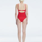 Model showing the back of the Lyra Red Swimsuit, revealing the sleek fit and moderate coverage.