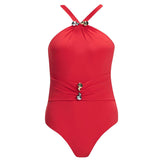 Lyra Red Swimsuit laid flat, highlighting the ruched detailing and vibrant Italian fabric.
