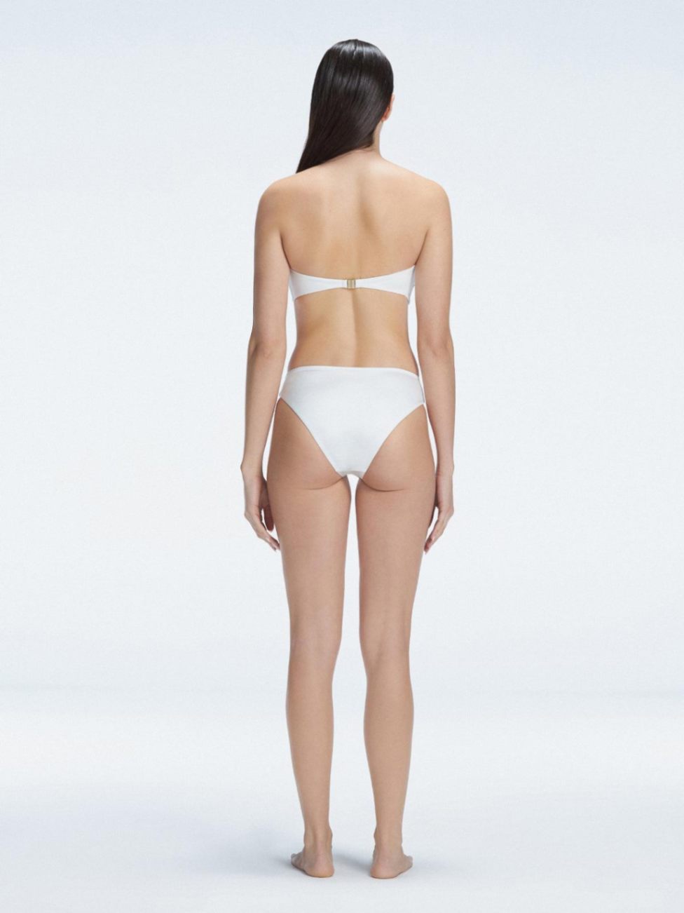 "Model wearing the IlanaWhite  Bikini Bottom from the back, showcasing the elegant bandeau design and adjustable straps."

