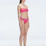 "Model in the Ilana Gradient Bikini Top viewed from the side, highlighting the stylish buckle detail and ruched accents."

