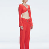 Side view of model showcasing the ruched front and buckle detail on the  Sirenia Red Crop Top and Helena Pants .
