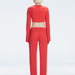 Back view of model showcasing the ruched layered panel and wide-legged fit on the Helena Red Pants.
