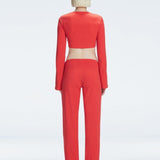 Back view of model showcasing the ruched layered panel and wide-legged fit on the Helena Red Pants.
