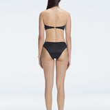 "Model wearing the Ilana Black Bikini Top from the back, showcasing the elegant bandeau design and adjustable straps."

