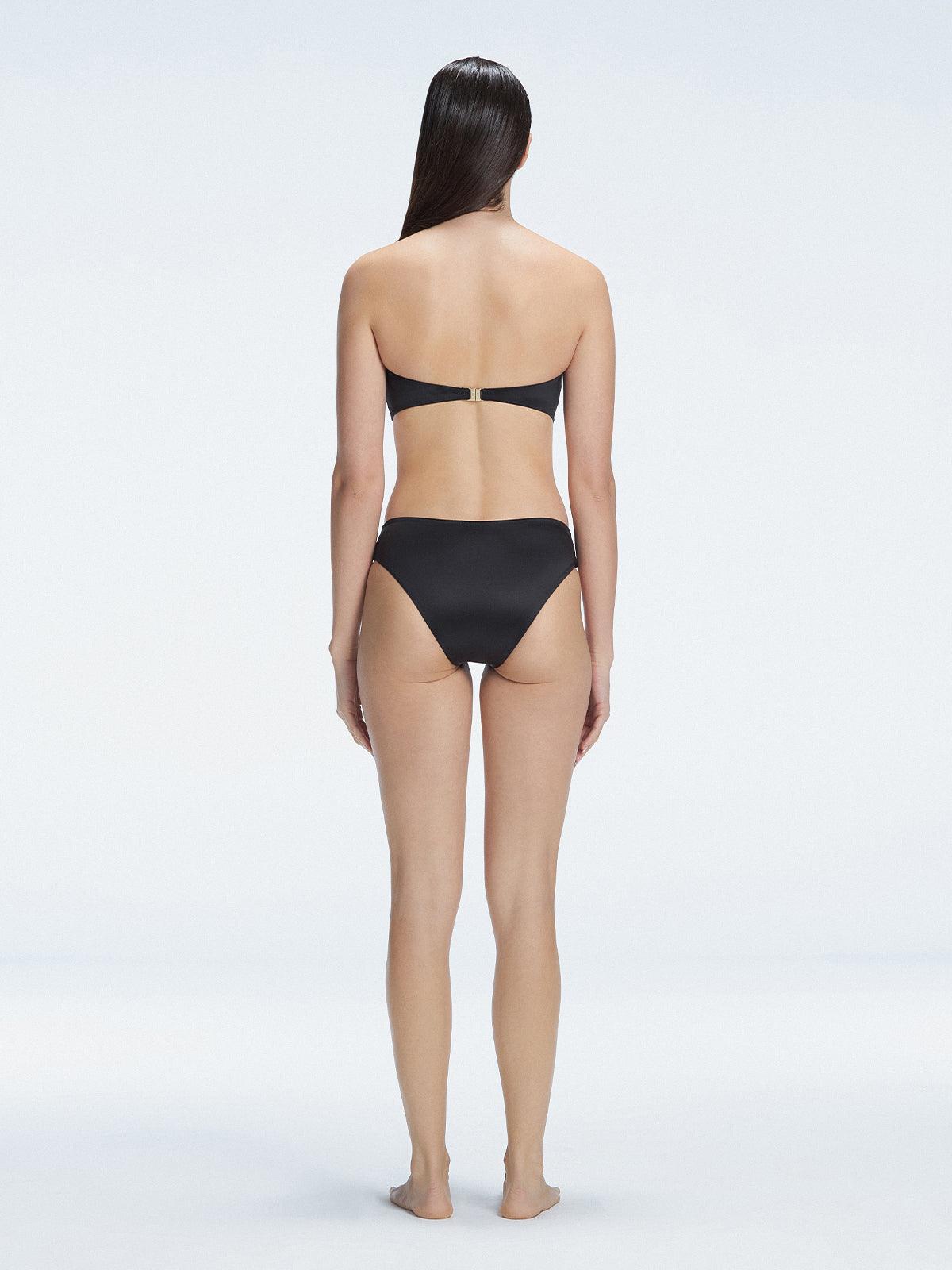 "Model wearing the Ilana Black Bikini Top from the back, showcasing the elegant bandeau design and adjustable straps."

