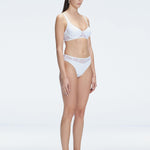 "Side view of the mesh detailing and scoop neck on the Lorelai White Bikini Top, emphasizing its stylish design."
