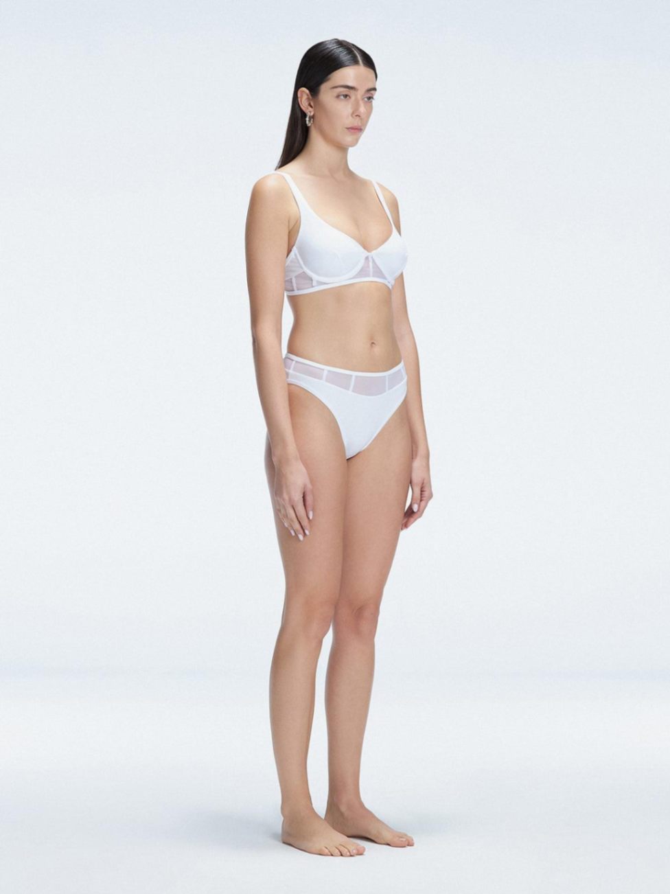 "Side view of the mesh detailing on the Lorelai White Bikini Set , emphasizing its chic aesthetic."
