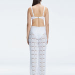 Back view of model wearing Elysia White Wide-Leg Pants, highlighting the relaxed fit and low-rise design.
