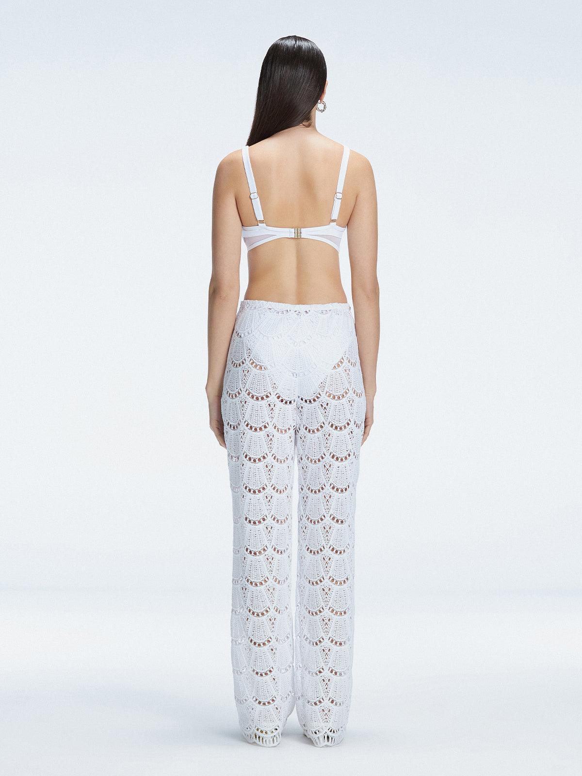 Back view of model wearing Elysia White Wide-Leg Pants, highlighting the relaxed fit and low-rise design.
