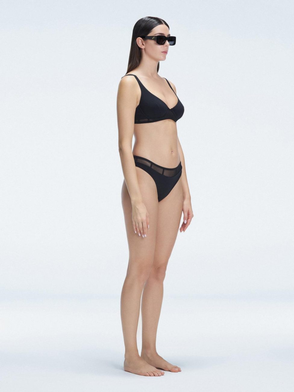 "Side view of the mesh detailing and scoop neck on the Lorelai Black Bikini Top, emphasizing its stylish design."
