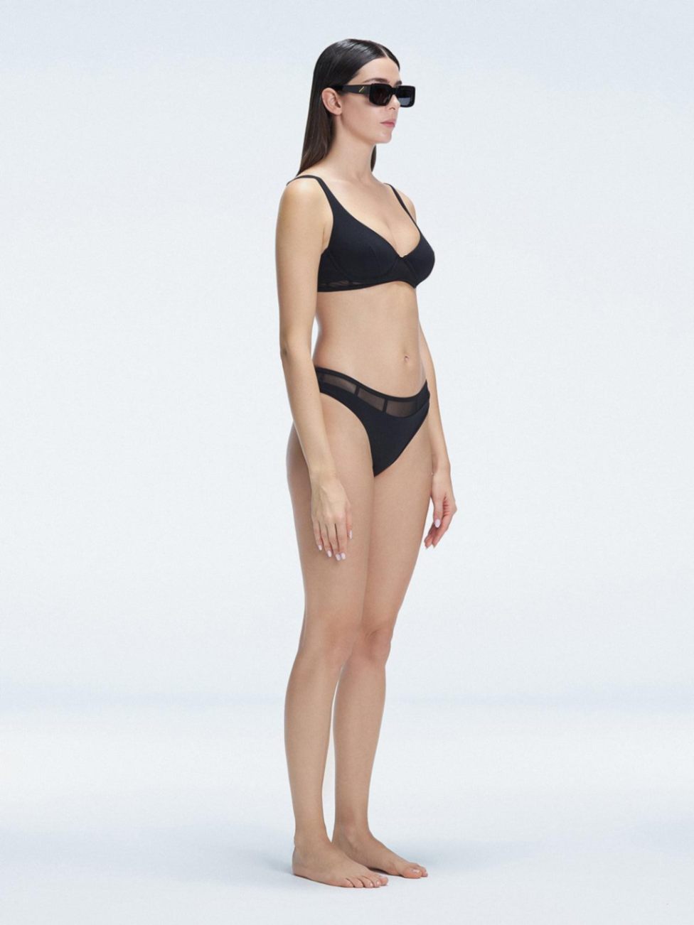 "Side view of the mesh detailing on the Lorelai Black Bikini Set , emphasizing its chic aesthetic."

