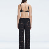 Back view of model wearing Elysia Black Wide-Leg Pants, highlighting the relaxed fit and low-rise design.
