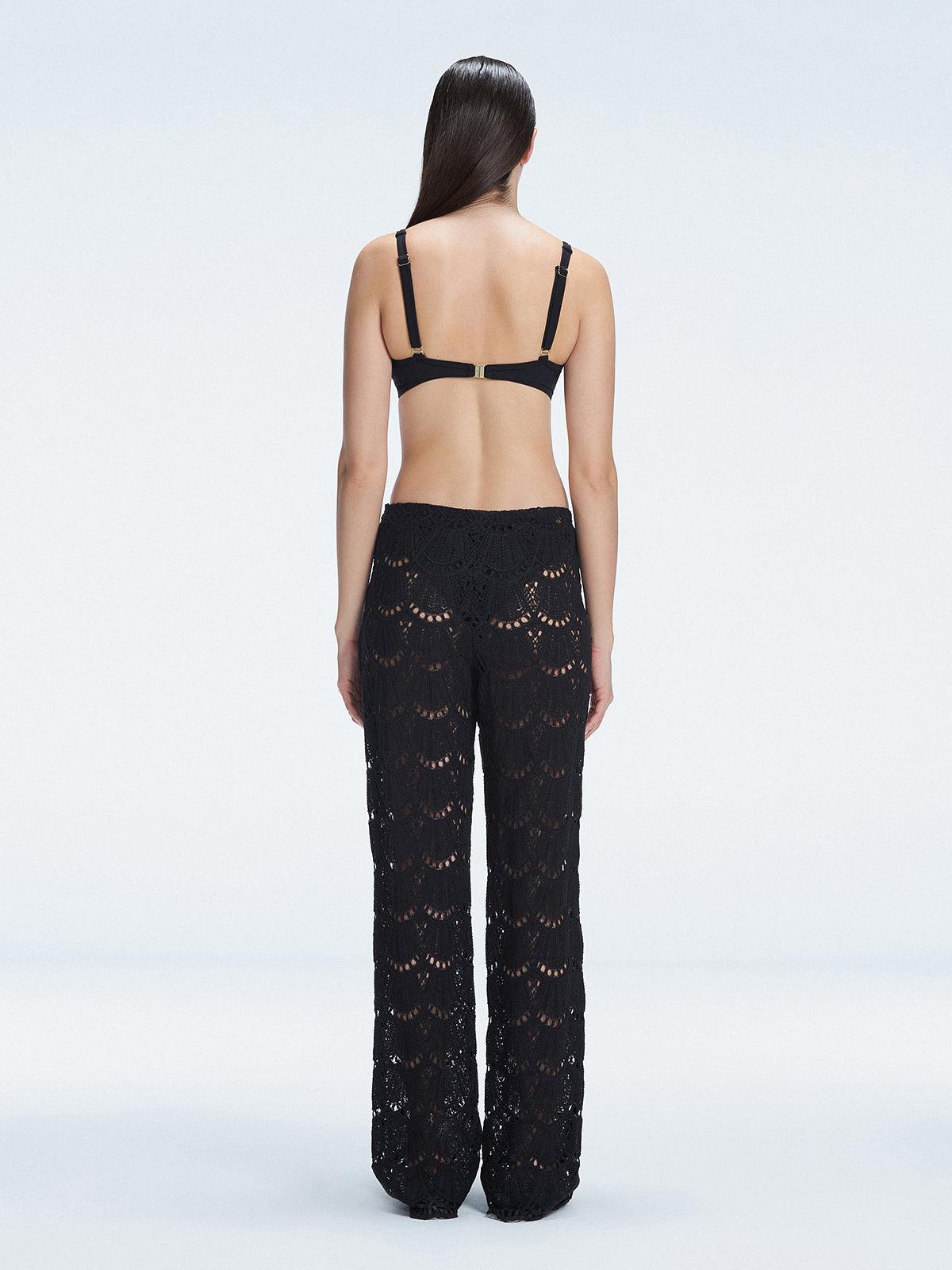 Back view of model wearing Elysia Black Wide-Leg Pants, highlighting the relaxed fit and low-rise design.
