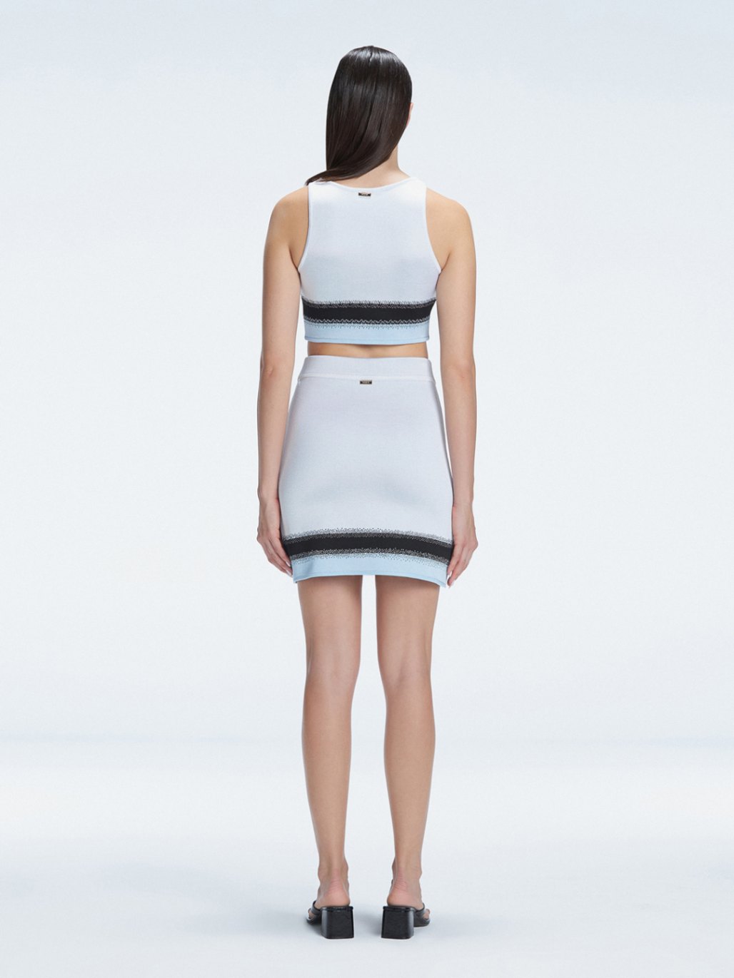 Back view of the asymmetrical hemline of the Lydia Mini Skirt, illustrating its modern design