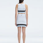 Back view of the asymmetrical hemline of the Lydia Mini Skirt, illustrating its modern design