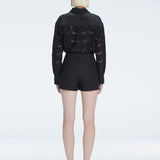 Back view of model wearing Elise Black Mini Skort, highlighting the skirt-shorts combination.
