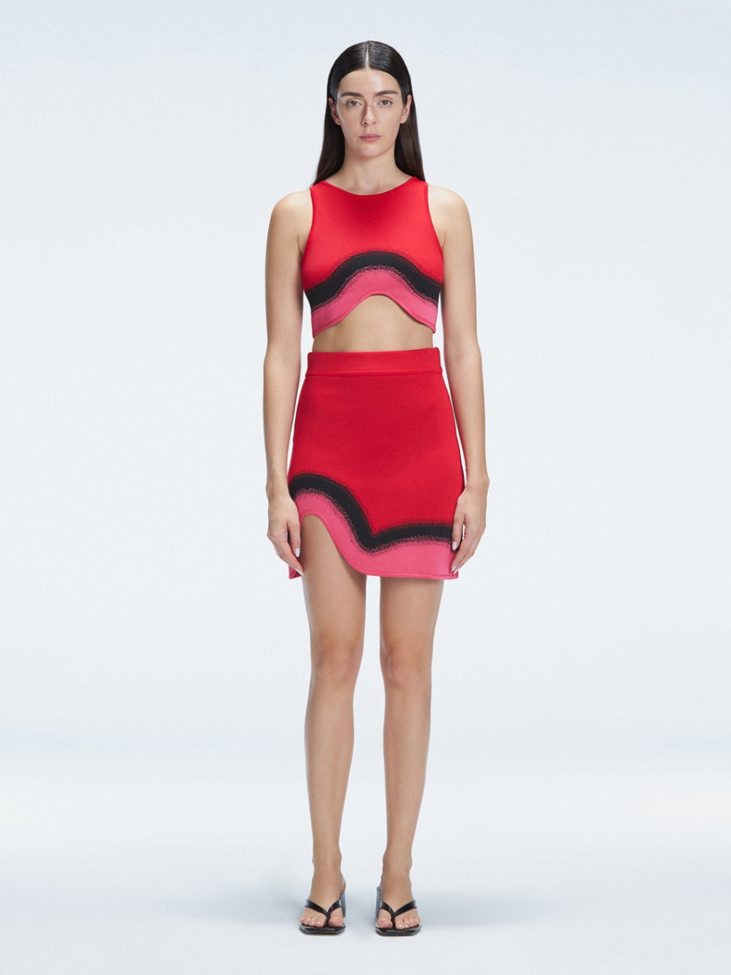Model showcasing the Cecilia Red Degraded Crop Top and Lydia Skirt Set highlighting its vibrant multicolored pattern.