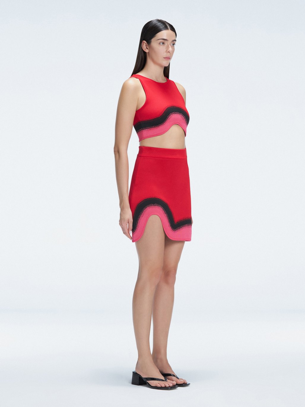 Side view of the Lydia Red Degraded Skirt, emphasizing its unique asymmetrical shape