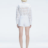 Back view of model wearing Nola White Short Elise Mini Skort, highlighting the skirt-shorts combination.
