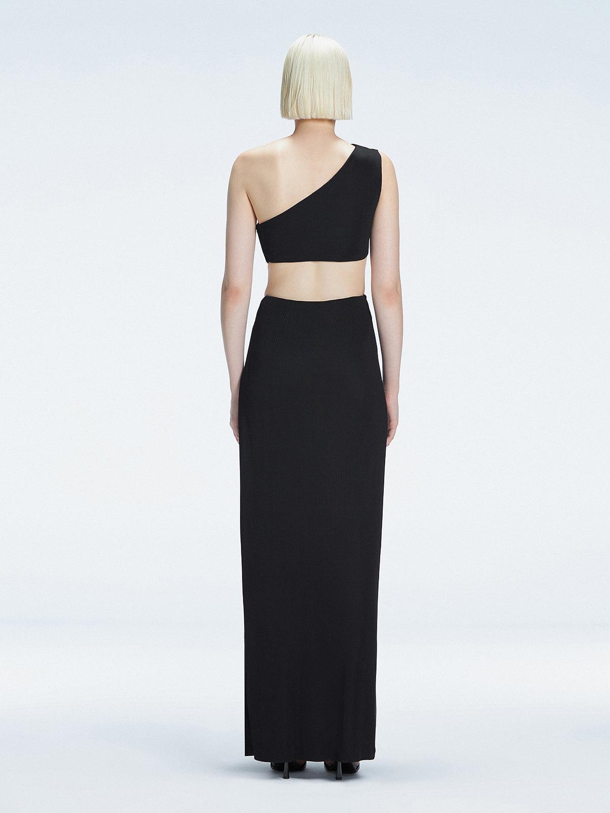 Back view of model wearing Violet Black Maxi Dress, highlighting the one-shoulder design and sleek fit.
