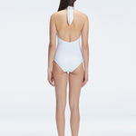 Back view of model wearing Rosamund White One Piece swimsuit, highlighting the low back and full bottom coverage.
