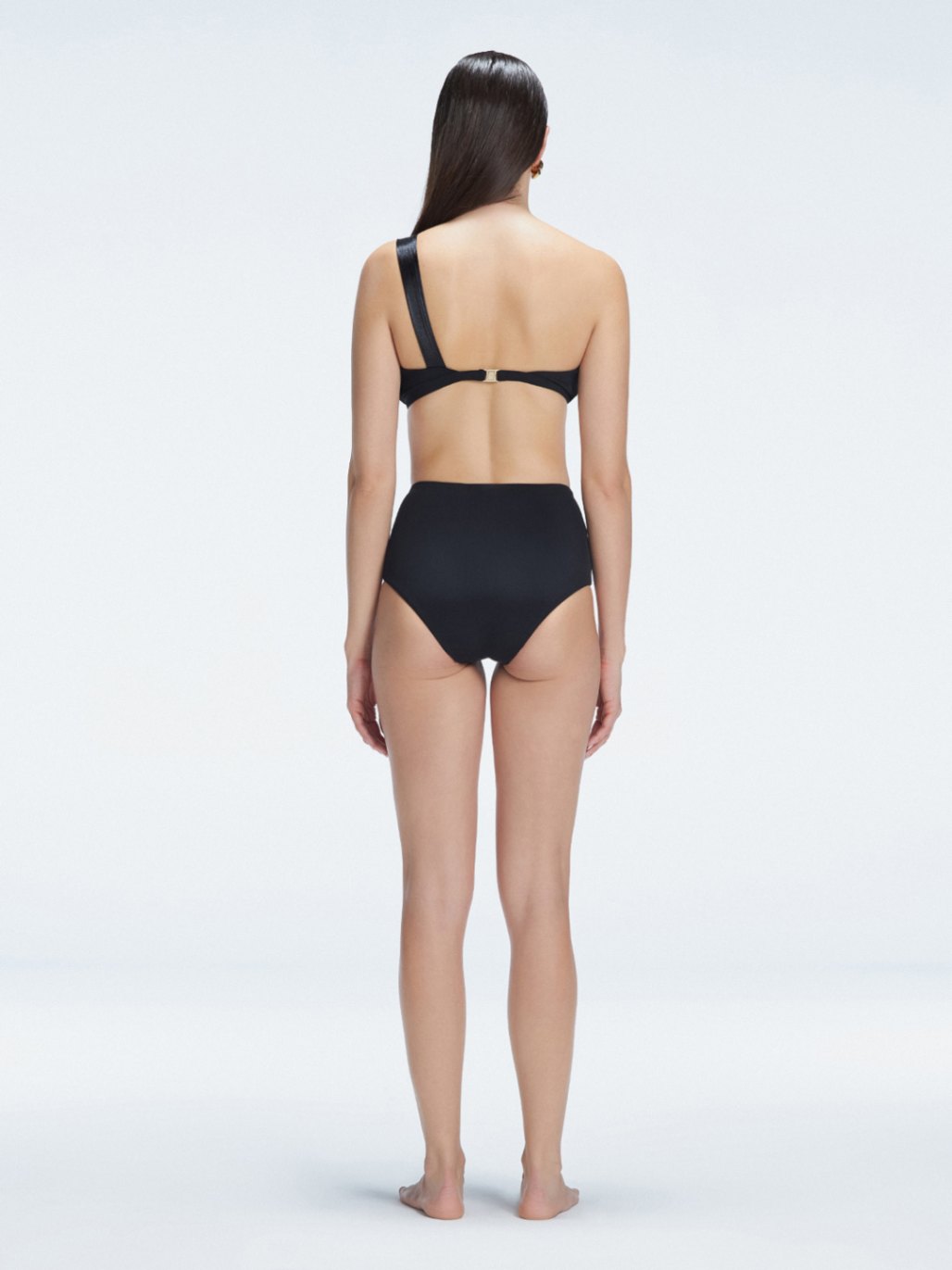 "Model showing the back of the Romina Black Bikini Set , highlighting the high-waist fit and sleek design."
