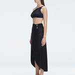 Side view of model showcasing the elegant front slip and wrap style on the Gina Black Skirt.
