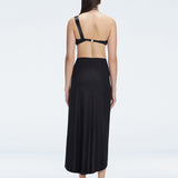 Back view of model wearing Gina Black Wrapped Skirt, highlighting the flowing silhouette and ankle-length design.
