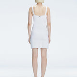 Back view of model wearing Heather White Dress, highlighting the sleek silhouette and adjustable straps.
